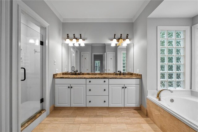 bathroom with large vanity, double sink, plus walk in shower, and a wealth of natural light