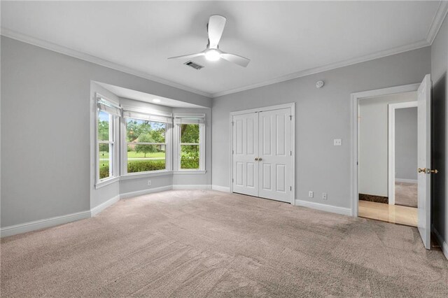 interior space with ceiling fan and ornamental molding