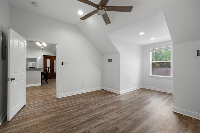 bonus room featuring vaulted ceiling, dark hardwood / wood-style flooring, and ceiling fan