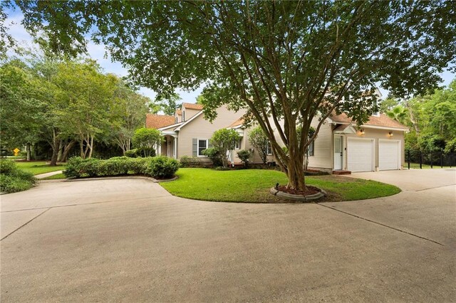 view of front of property with a garage and a front yard