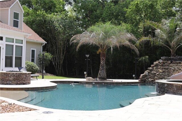 view of swimming pool with a patio and pool water feature