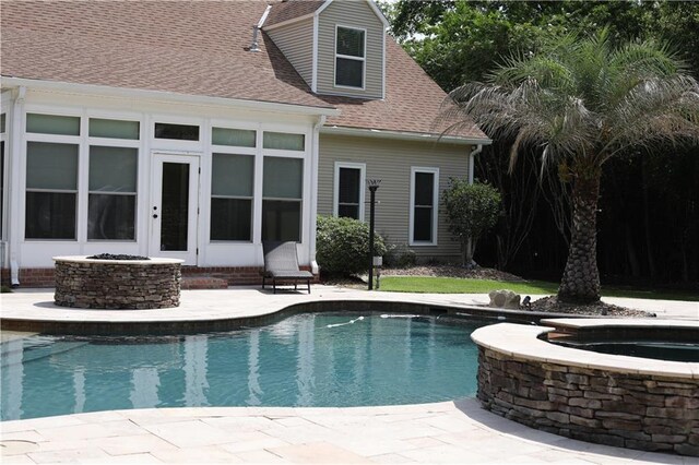 view of pool with a patio and an in ground hot tub