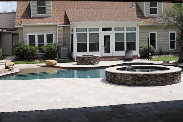 view of swimming pool featuring a patio area, central AC, and an in ground hot tub