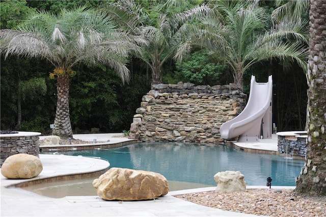 view of swimming pool featuring a water slide