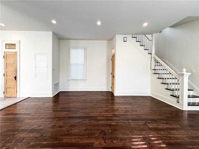 unfurnished living room featuring dark wood-type flooring