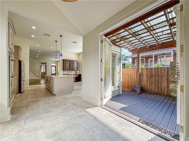 entryway featuring sink and vaulted ceiling