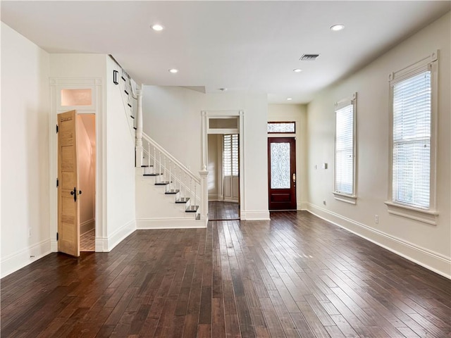 entrance foyer with a wealth of natural light and dark wood-type flooring