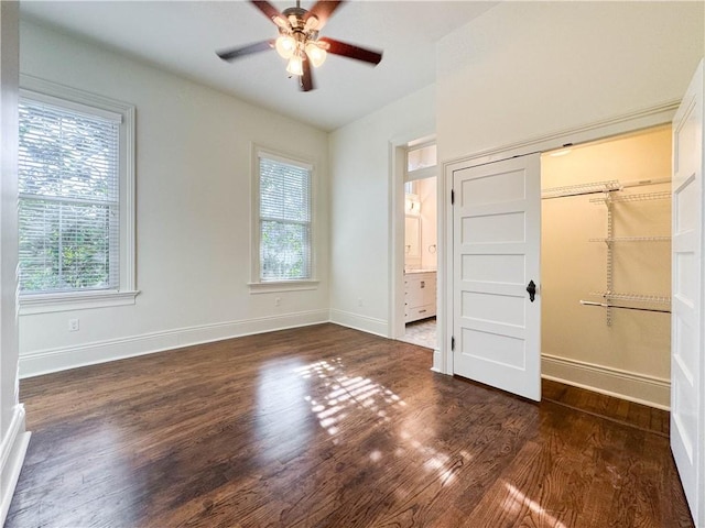 unfurnished bedroom featuring ceiling fan, dark hardwood / wood-style flooring, and a closet