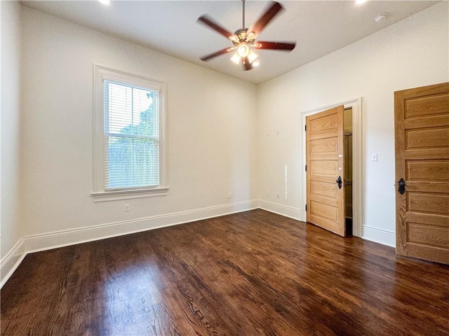 unfurnished room featuring ceiling fan and dark hardwood / wood-style floors