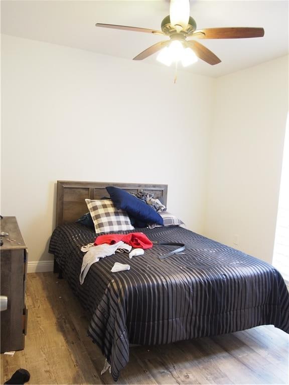 bedroom with ceiling fan and hardwood / wood-style floors