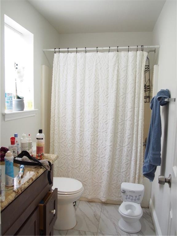 bathroom with tile flooring, vanity, and toilet