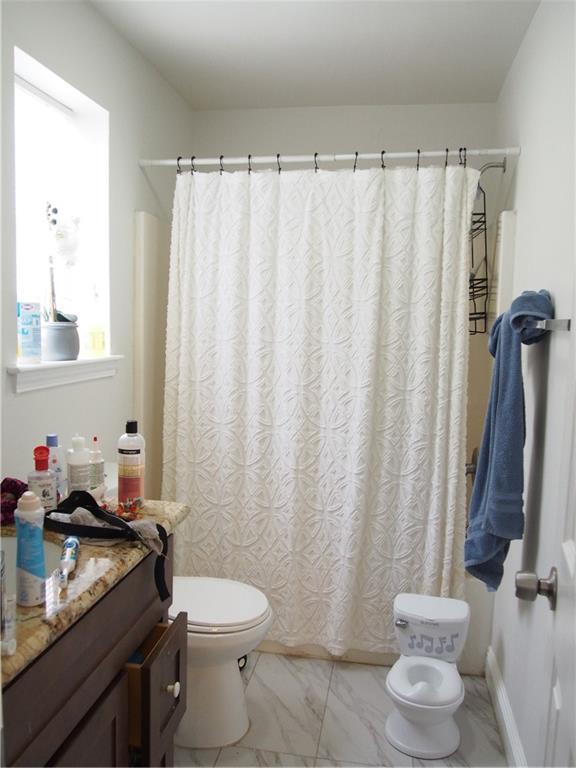 3604-06 3612-14 3616-18 3rd St, New Orleans, LA 70125 - bathroom with vanity, marble look tile flooring, and curtained shower