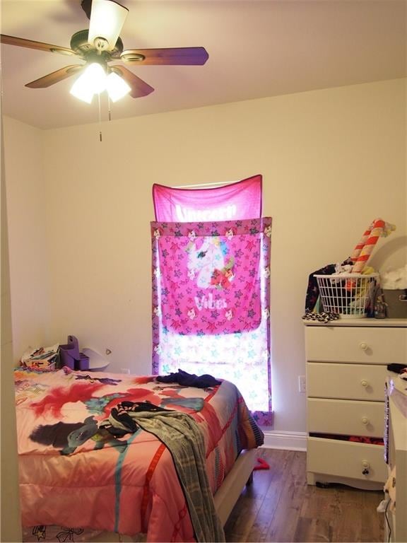 bedroom with dark wood-type flooring and ceiling fan