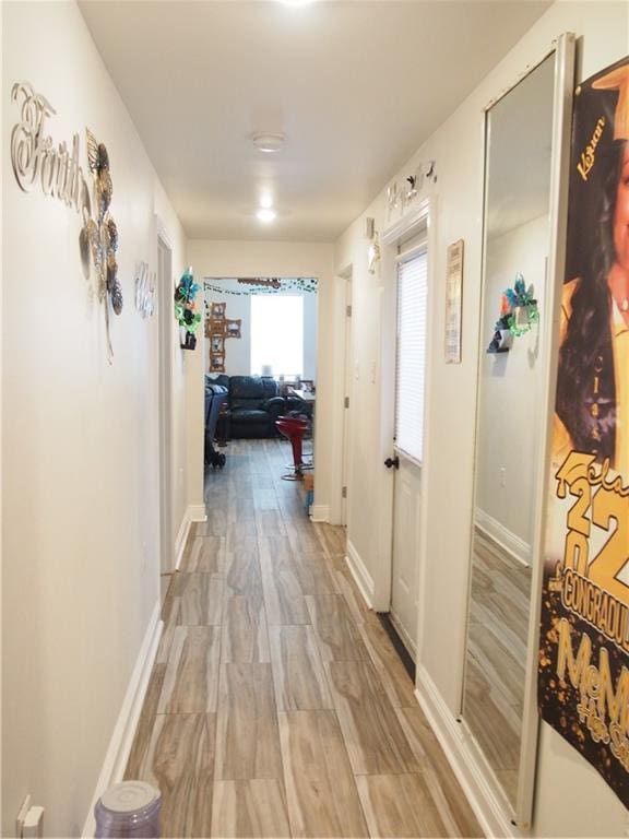 hallway with hardwood / wood-style floors