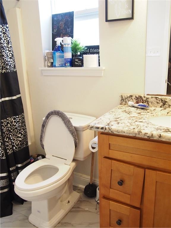 bathroom featuring toilet, tile floors, and large vanity