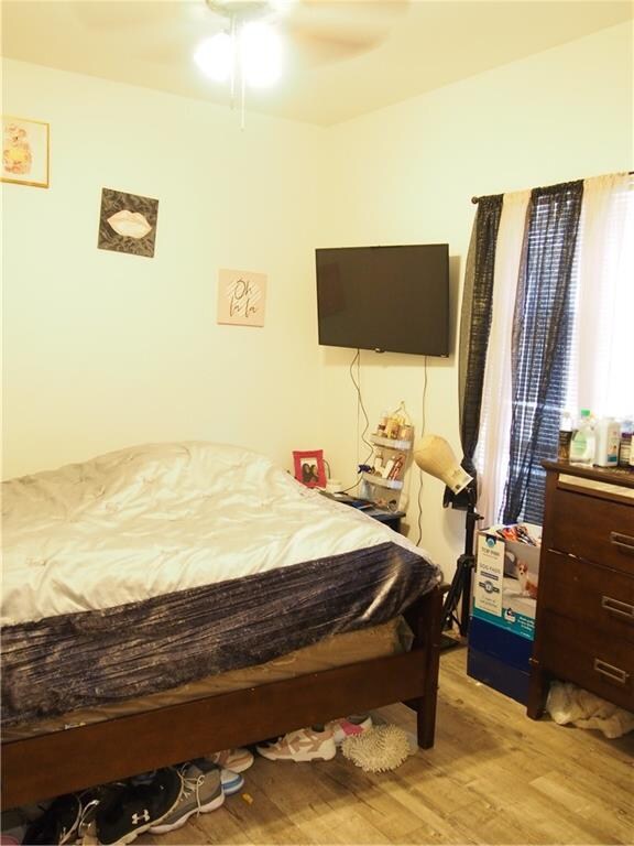 bedroom with ceiling fan and light wood-type flooring