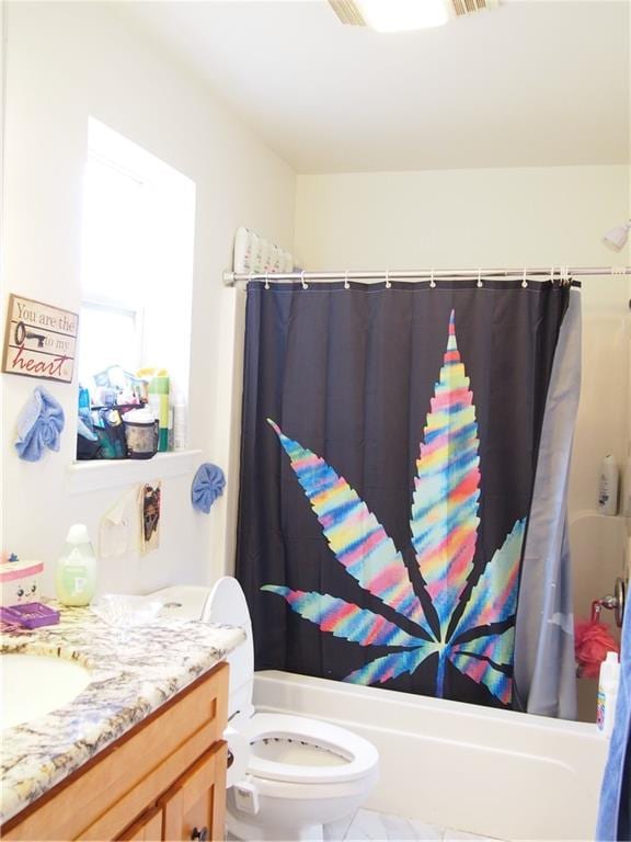 full bathroom with tile floors, toilet, vanity, and shower / bath combo