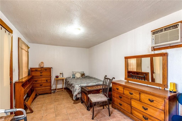 4102 Dauphine St, New Orleans, LA 70117 - tiled bedroom featuring a wall mounted air conditioner and a textured ceiling