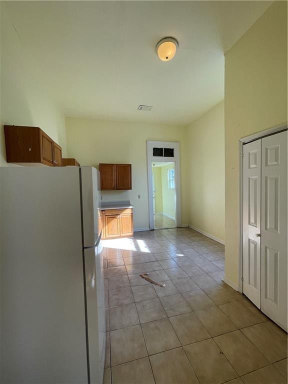 kitchen featuring light tile patterned flooring and white refrigerator