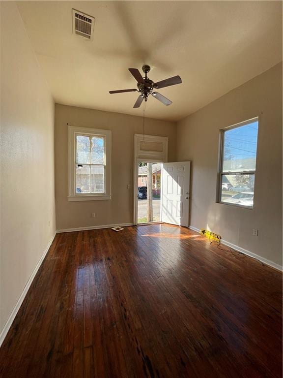 empty room with dark hardwood / wood-style flooring and ceiling fan