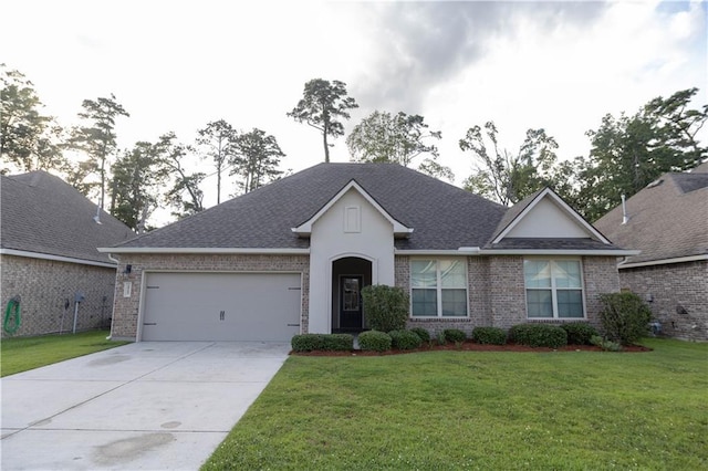 view of front of house featuring a front yard and a garage