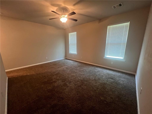 carpeted spare room with ceiling fan