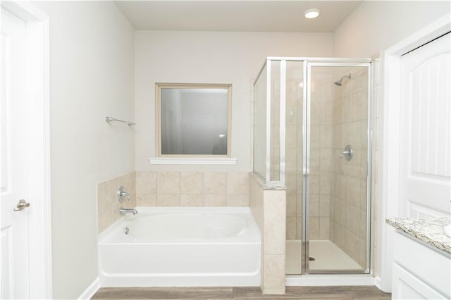 bathroom featuring vanity and plus walk in shower