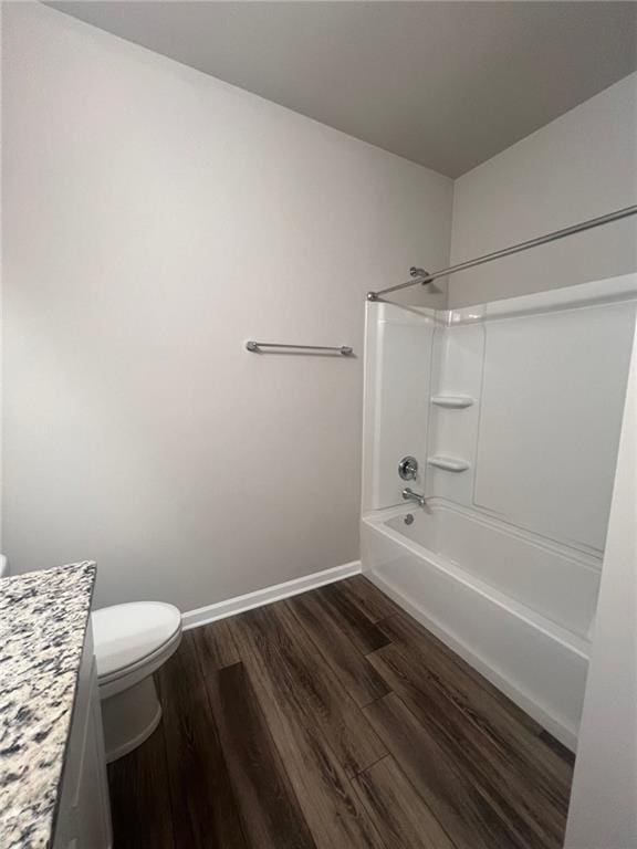 full bathroom with hardwood / wood-style floors, vanity, shower / bath combination, and toilet