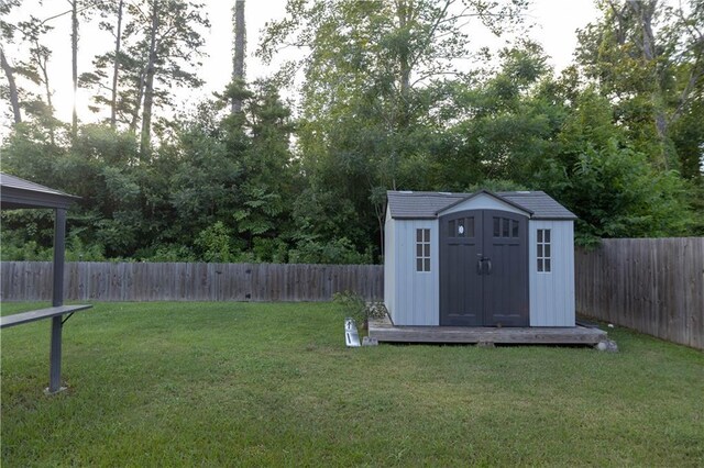 view of outdoor structure featuring a lawn