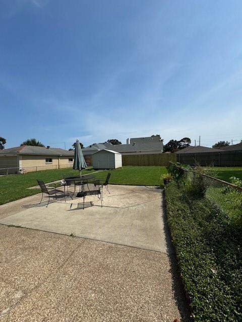 view of patio featuring a storage unit