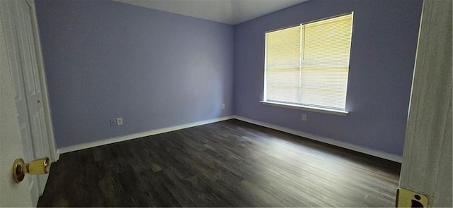 empty room with dark hardwood / wood-style floors