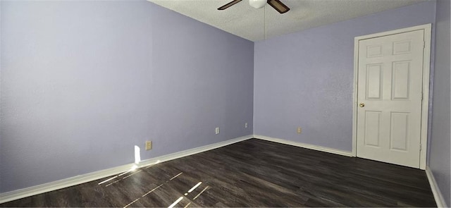 spare room featuring a textured ceiling, ceiling fan, and dark wood-type flooring