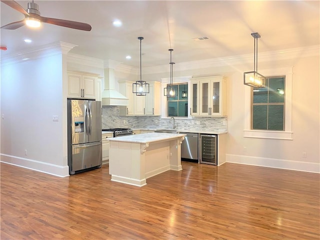 154749 N Galvez St, New Orleans, LA 70119 - kitchen with appliances with stainless steel finishes, wine cooler, wall chimney exhaust hood, decorative backsplash, and a ceiling fan