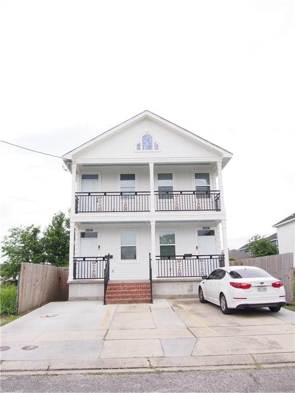 view of front of house with a balcony and covered porch