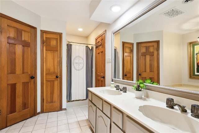 bathroom with tile patterned flooring, vanity, and curtained shower