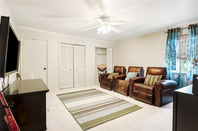 carpeted living room with ceiling fan