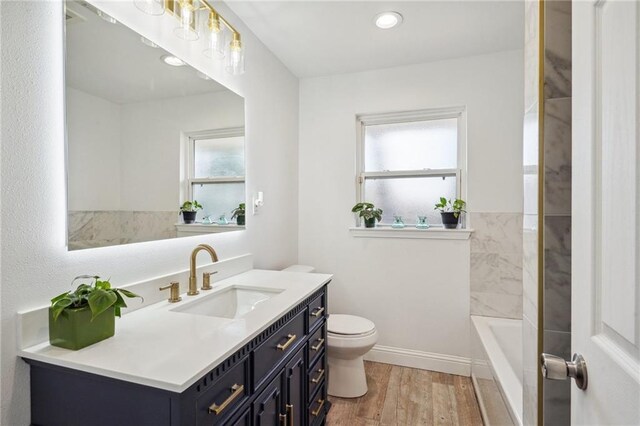 bathroom with hardwood / wood-style floors, oversized vanity, and toilet