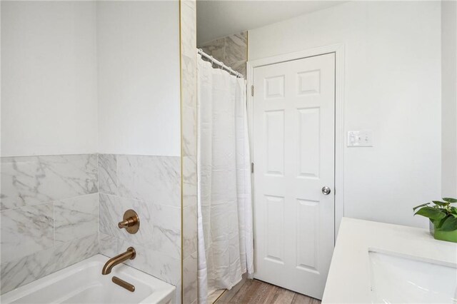 bathroom featuring shower / bathtub combination with curtain and hardwood / wood-style floors