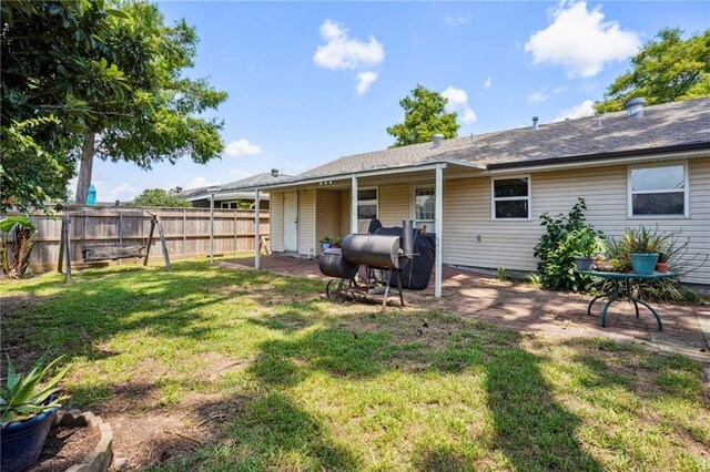 back of house with a lawn