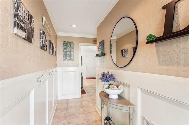 corridor featuring light tile patterned floors and crown molding