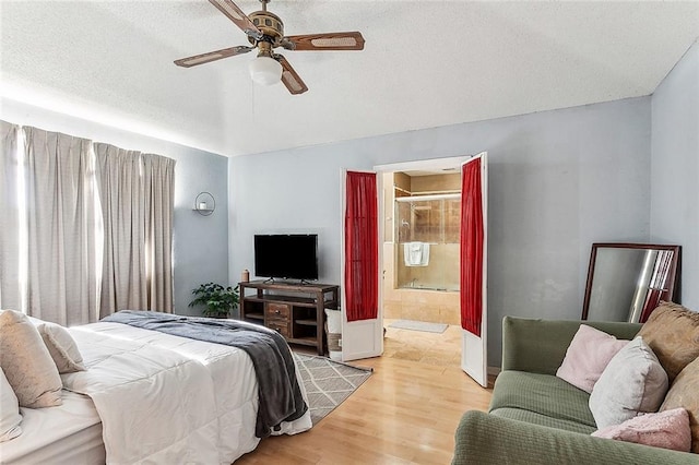 bedroom with ceiling fan, light wood-type flooring, and connected bathroom