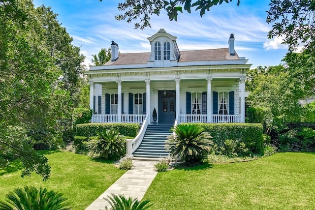 view of front of property with a front yard and a porch