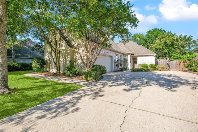 view of front of home with a front yard and a garage