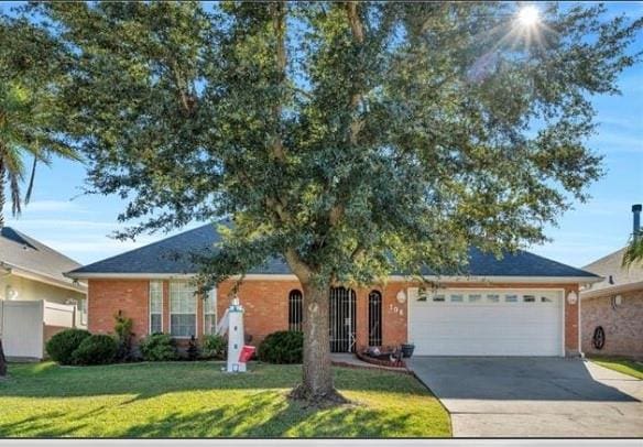 ranch-style house with a front yard and a garage