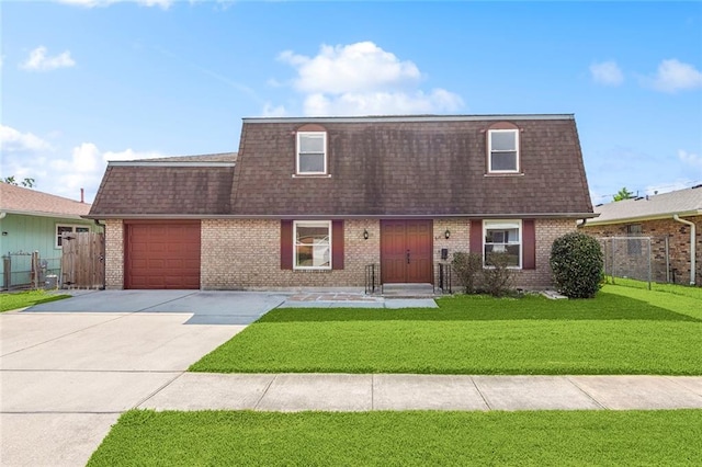 view of front facade with a garage and a front lawn