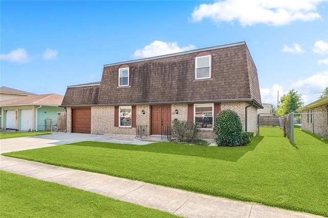 view of front of home featuring a front yard and a garage