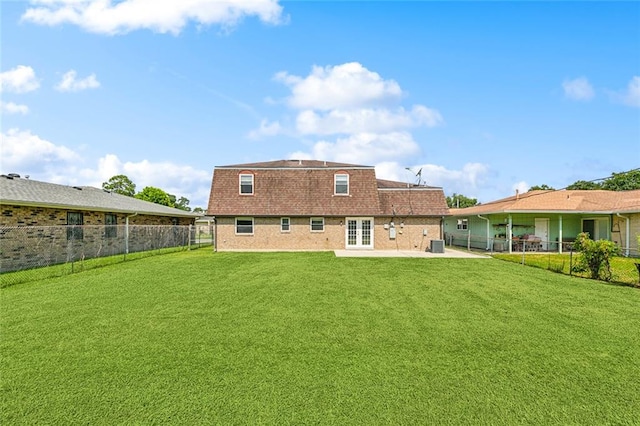 rear view of house featuring a lawn and a patio area