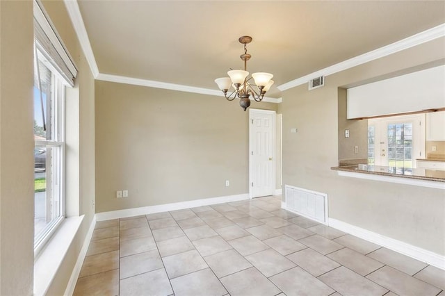 tiled spare room with crown molding and a chandelier