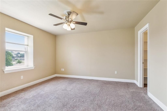 unfurnished room featuring carpet floors and ceiling fan