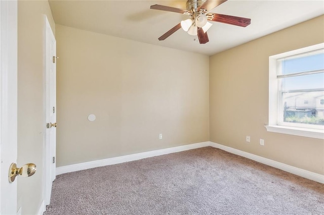 carpeted spare room featuring plenty of natural light and ceiling fan